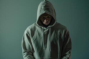 Hoodie Clad Male with Sage Green Background emphasizing Contemporary Fashion and Lifestyle Trends in a Trendy portrait Style photo