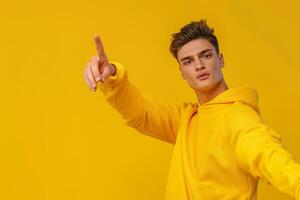 Bright Yellow Background with Sweatshirt Clad Male Lifestyle portrait emphasizing energetic Fashion and Vibrant Style photo