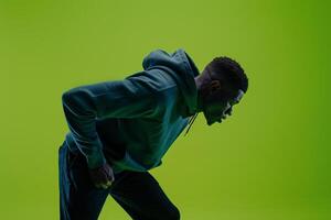 Bright Lime Green Background with Hoodie Clad Male Lifestyle portrait Highlighting Fashion and Trendy Look photo