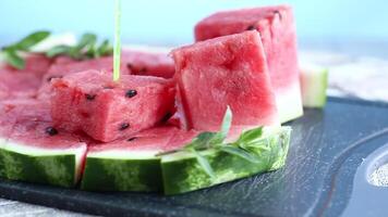pieces of ripe red watermelon, close-up, on a board video