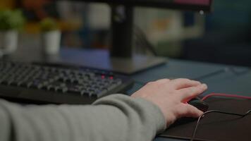 Close-up of man hands gamer playing game using RGB keyboard during virtual championship in cyberspace. Online streaming cyber performing on powerful personal computer during gaming tournament video
