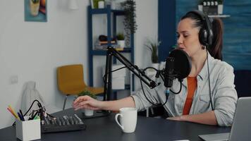 Creative digital content creator adjusting sound and microphone height while recording podcast. Popular internet influencer presenting to public worldwide events while filming vlog. video