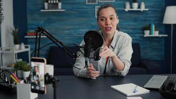 Creative social media tech star reviewing wireless mouse in living room studio. Digital content creator recording presentation of electronic computer peripheral while video