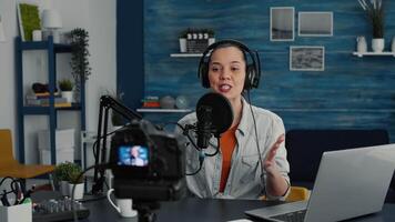 Cheerful popular internet podcast show host ending live stream while sending air kisses to public. Social media popular infulencer saying goodbye to audience while sitting at home studio desk. video