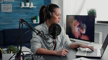 Radio talk show host answering audience questions on laptop while recording . Creative content creator chatting with public on live chat while speaking on modern microphone. video