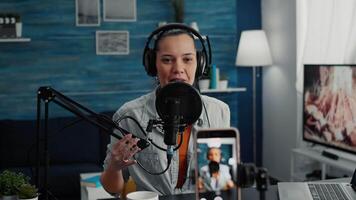 Popular content creator streaming live daily vlog using smartphone while talking to public. Online live radio talk show host discussing last worldwide news and evens with public. video