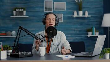 Creative digital content creator filming daily blog. Internet live talk show host speaking to audience about last world events and news while sitting at home studio desk. video