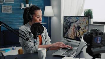 Creative digital content creator answering audience questions while streaming live on internet. Famous social media influencer using laptop while broadcasting remote podcast show. video