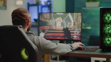 Professional cyber gamer playing shooter videogame with new graphics on powerful computer from gaming room. Virtual shooter game performing in cyberspace, esports player esports online tournament video