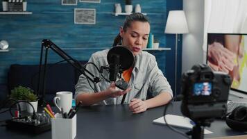 Popular tech enthusiast doing review of modern wireless mouse while presenting specifications. Digital content creator recording clip of electronic device in living room studio. video