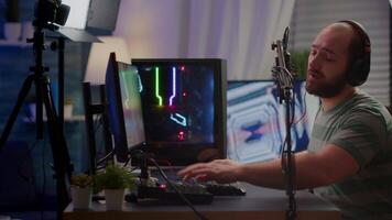 Professional digital player with headphones streaming game with modern graphics for shooter online game championship. Pro gamer checking sound at mixer playing online game in gaming studio video