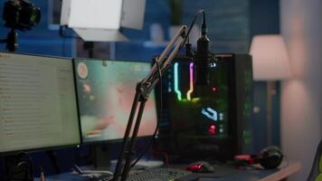 Game is over on display of RGB professional powerful computer and stream chat is prepared for virtual tournament. Streaming professsional microphone in empty gaming home studio with neon lights. video