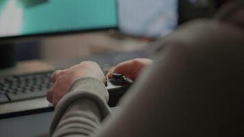 Close up on hands of gamer playing using wireless joystick in cyberspace sitting on gaming chair. Cyber man holding controller performing space shooter games at online esports championship video