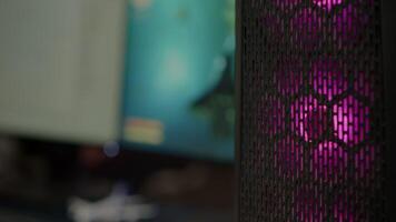 Close up of RGB system desktop prepared for e sport online tournament. Powerful personal computer for online videogames with space shooter game on screen. Cozy gaming room with modern design video