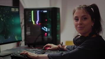 Concentrated gamer looking at camera while playing space shooter online game on RGB powerful personal computer during egames championship. Esport cyber performing during gaming tournament video