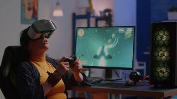 Videogame player with vr goggles raising hands after winning space shooter competition wearing headset dancing. Professional pro cyber woman playing online game with new graphics on powerful computer video