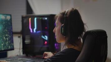 Professional eSport gamer with headset playing in competitive games on cyber gaming tournament. Virtual championship in cyberspace, esports player performing on RGB powerful personal computer video
