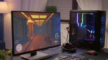 Close-up of empty gaming home studio equipped with RGB powerful system desktop, keyboard, mouse and professional headphones. Gamer playing first person shooter for online esport competition video