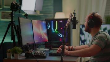 Competitive player streaming esport tournament checking sound mixer, stream chat and professional microphone. Competitive man playing online space shooter gaming competition on powerful computer video