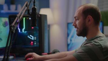 Focused streamer gamer looking at camera preparing streaming space shooter online game playing on RGB powerful computer during egames championship. Esport cyber performing in gaming tournament video