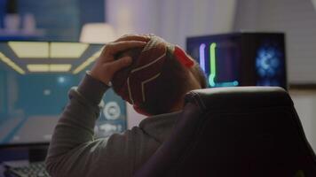 Back view shot of professional gamer playing in first-person shooter online game on powerful computer. Virtual championship in cyberspace, esports player performing during gaming tournament. video