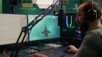 Pro streamer man playing space shooter games during online competition using professional setup with chat open. Gamer streaming games on professional powerful computer video