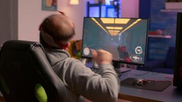 Cyber gamer stretching hands and neck before playing online games using RGB keyboard and mouse. Player performing online games during gaming tournament video