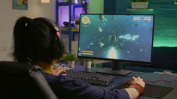Videogame player losing space shooter competition while wearing professional headset. Defeated gamer using technology network wireless for online tournament late at night in gaming room video