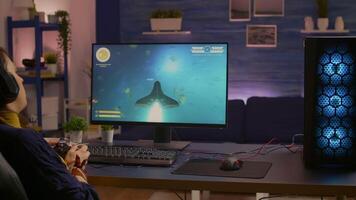 Pro gamer playing space shooter online championship with modern graphics using wireless controller. Competitive player streaming game tournament using professional equipment at gaming studio video