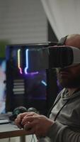 Vertical . Pro cyber sport gamer wining playing games using vr headset. Virtual space shooter game championship in cyberspace, esports player performing on powerful computer during gaming tournament video