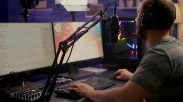 Professional digital player with headphones streaming game with modern graphics for shooter online game championship. Pro gamer playing digital game in gaming studio video