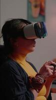 Vertical . Player woman wining space shooter game using virtual reality goggles playing games with modern joystick. Professional cyber gamer streaming online games with new graphics on powerful computer video