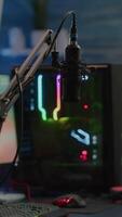 Vertical . Game is over on display of RGB professional powerful computer and stream chat is prepared for virtual tournament. Streaming professsional microphone in empty gaming home studio with neon lights. video