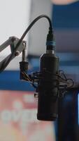 Vertical . Streaming professsional microphone in empty gaming home studio with neon lights. Game is over on display of RGB professional powerful computer and stream chat is prepared for virtual tournament video