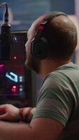 Vertical . Nevous streamer losing videogame, game over for man cyber playing online space shooter games with headset. Player performing on powerful computer talking with players on chat in gaming competition video