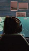 Vertical . Upset professional woman gamer wearing headset losing space shooter game in cybersport competition. Tired pro cyber player gaming online games on powerful personal computer with RGB lights. video