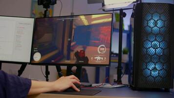 Close-up of streamer playing first person shooter game using RGB keyboard and mouse. Gamer talking on streaming chat with other players during esport tournament late at night in gaming studio video