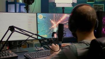 Streamer with headphone losing space shooter game competition using modern equipment. Player sitting on streaming chair use wireless console and talking with other players on streaming chat video