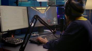 Pro streamer check sound on mixer and start playing first person shooter game during virtual competition. Gamer using professional streaming setup late at night in gaming home studio video