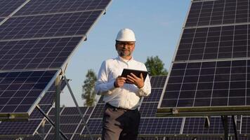 Portrait Of Senior Inspector Engineer With Digital Tablet in Solar Panels Power Farm video