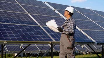 Indian engineer checks technical documentation of the solar station after installation video