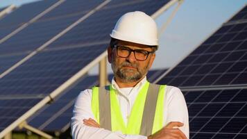 Portrait of senior engineer on solar panels station. Concept of alternative and renewable energy video