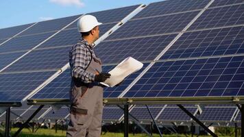 Indian engineer checks technical documentation of the solar station after installation video