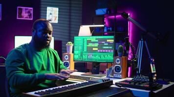 Famous piano teacher conducting internet master class via vlog tutorial, teaching people how to hit the right notes on electronic keyboard. Young artist performer hosts synthesizer lessons. Camera B. video