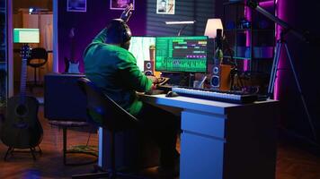 Sound engineer mixing and mastering new music on console and daw software in home studio, twisting pre amp knobs. Talented composer producing songs for the industry. Camera B. video