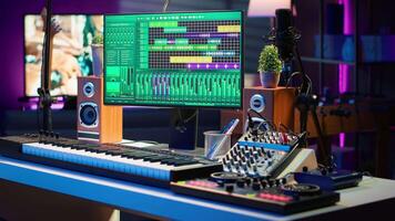 Empty home studio desk with DAW software and mixing console used for mixing and mastering tracks, post production. Professional sound recording devices and modern gear, music industry. video