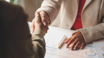 Handshake as successful negotiation ending, close-up. Unknown business people shaking hands after contract signing in modern office video