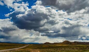 Rain clouds during the day over the plains in Utah, US photo