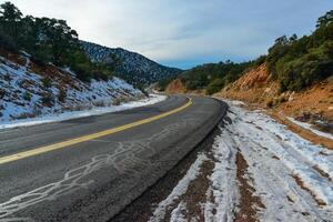 Snowy mountains and snow along the road on a mountain pass in the Death Valley area photo