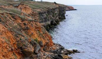 An impregnable precipitous rocky shore in the eastern Crimea photo